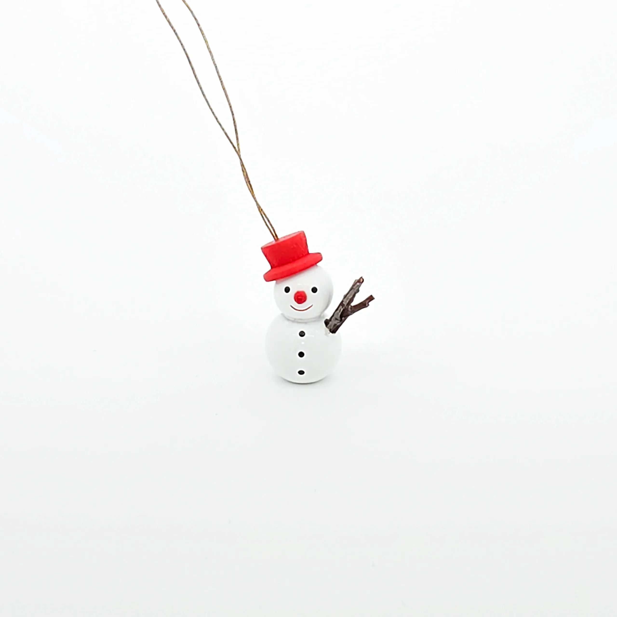 kleine weiße Schneemänner hängend mit rotem Hut