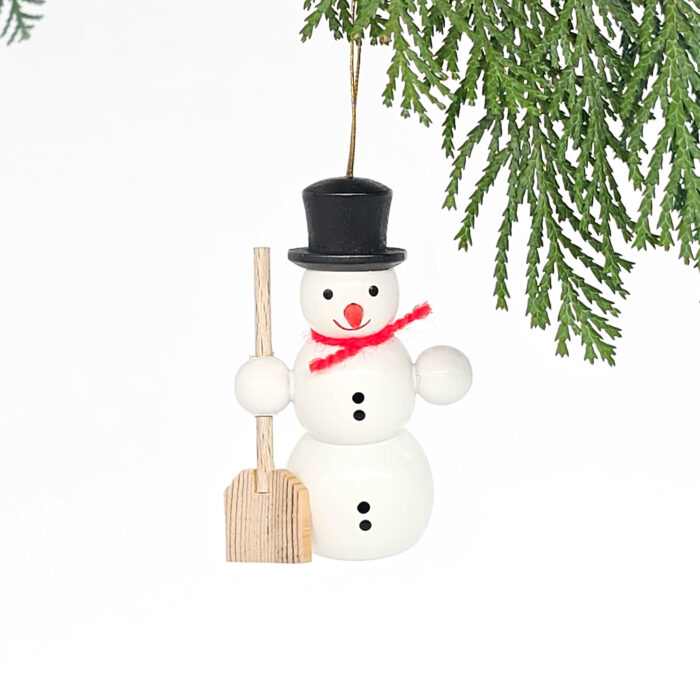 kleiner weißer Holzschneemann hängend mit Schippe