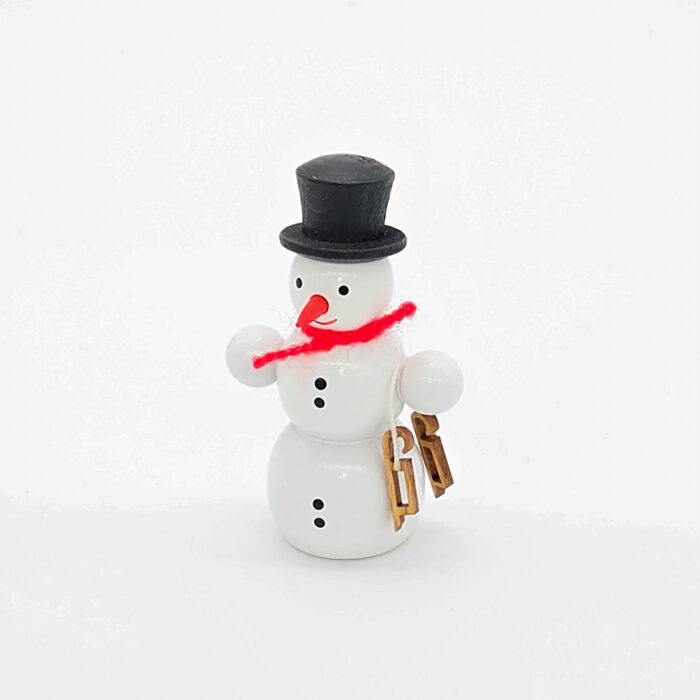 kleiner weißer Holzschneemann mit Schlittschuh